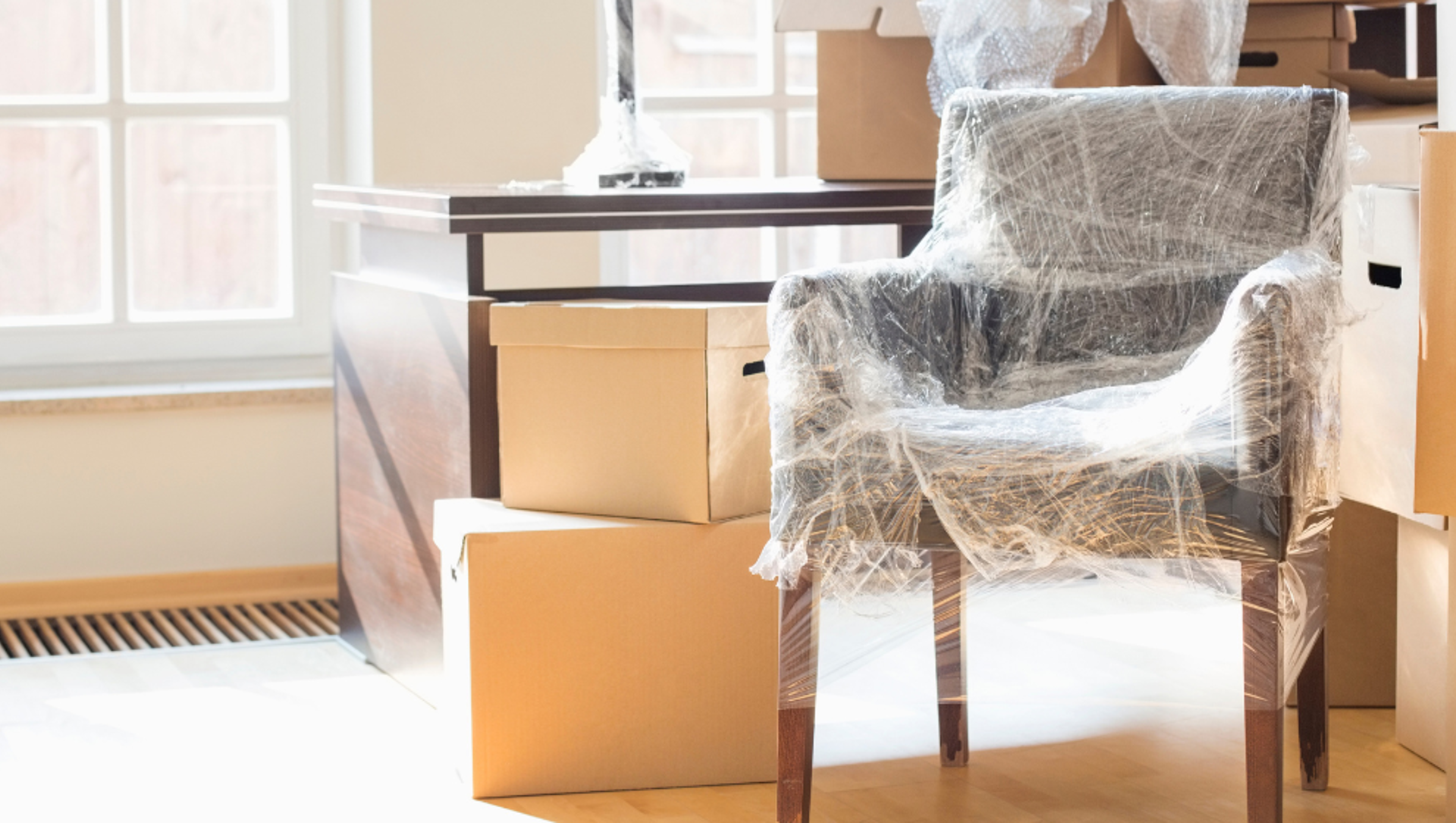 A stack of cardboard boxes and furniture packed for removal