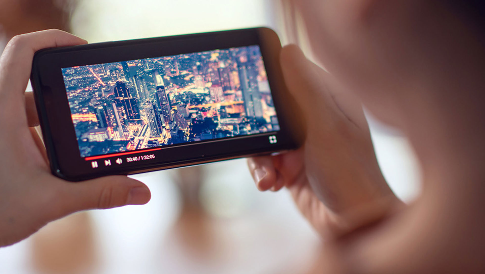 Young person watching a video on a mobile phone 