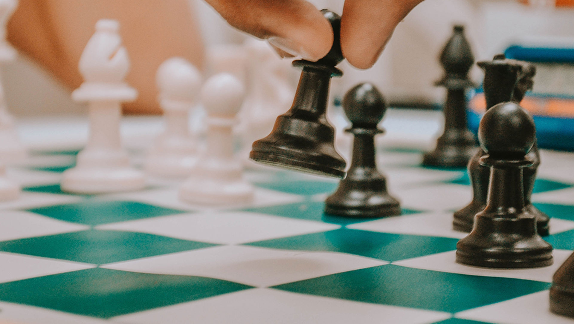 Someone moving chess pieces on a chess board