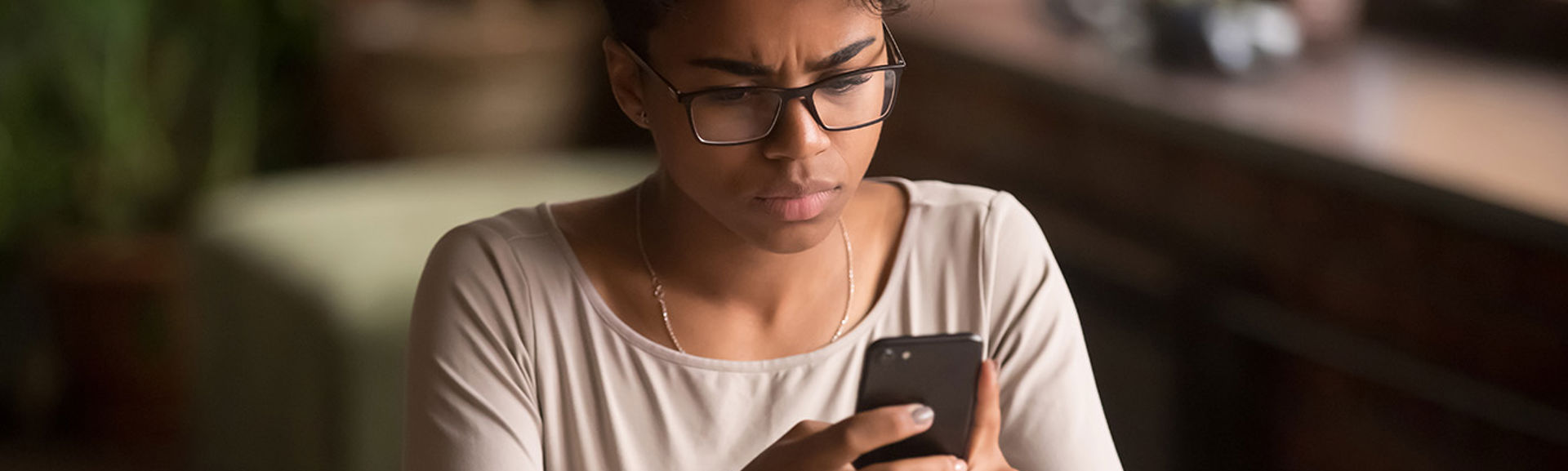 teenager using smartphone with upset look on her face.