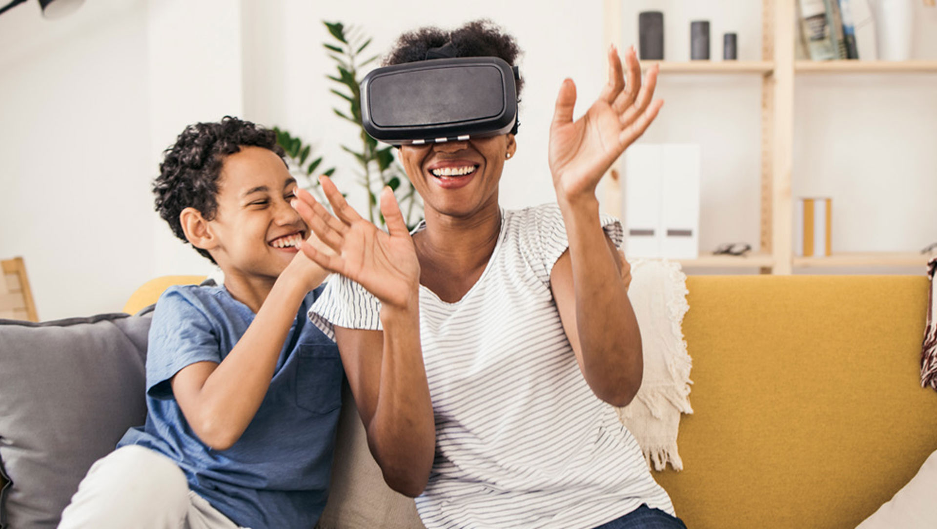 Mother and son using a virtual reality headset and having fun