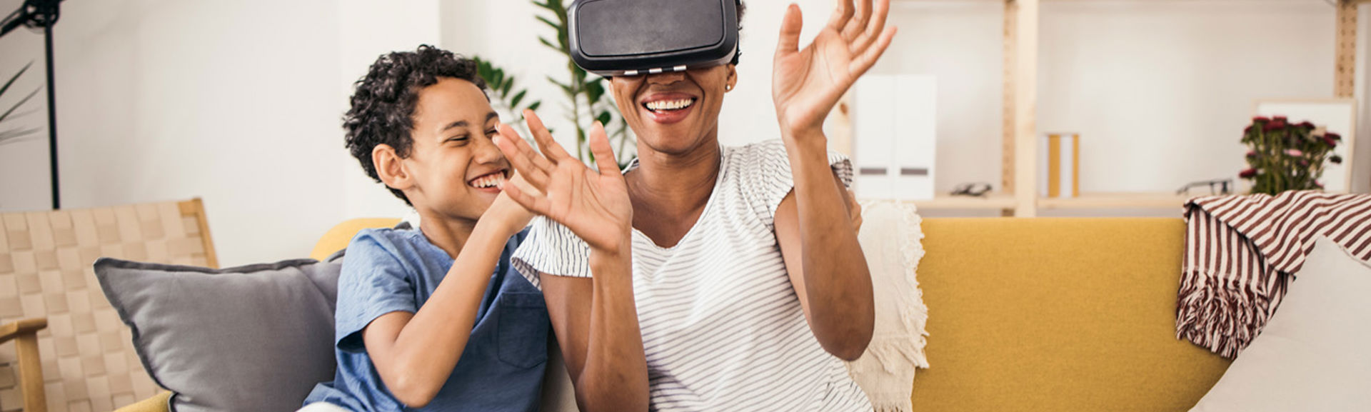 Mother and son using a virtual reality headset and having fun