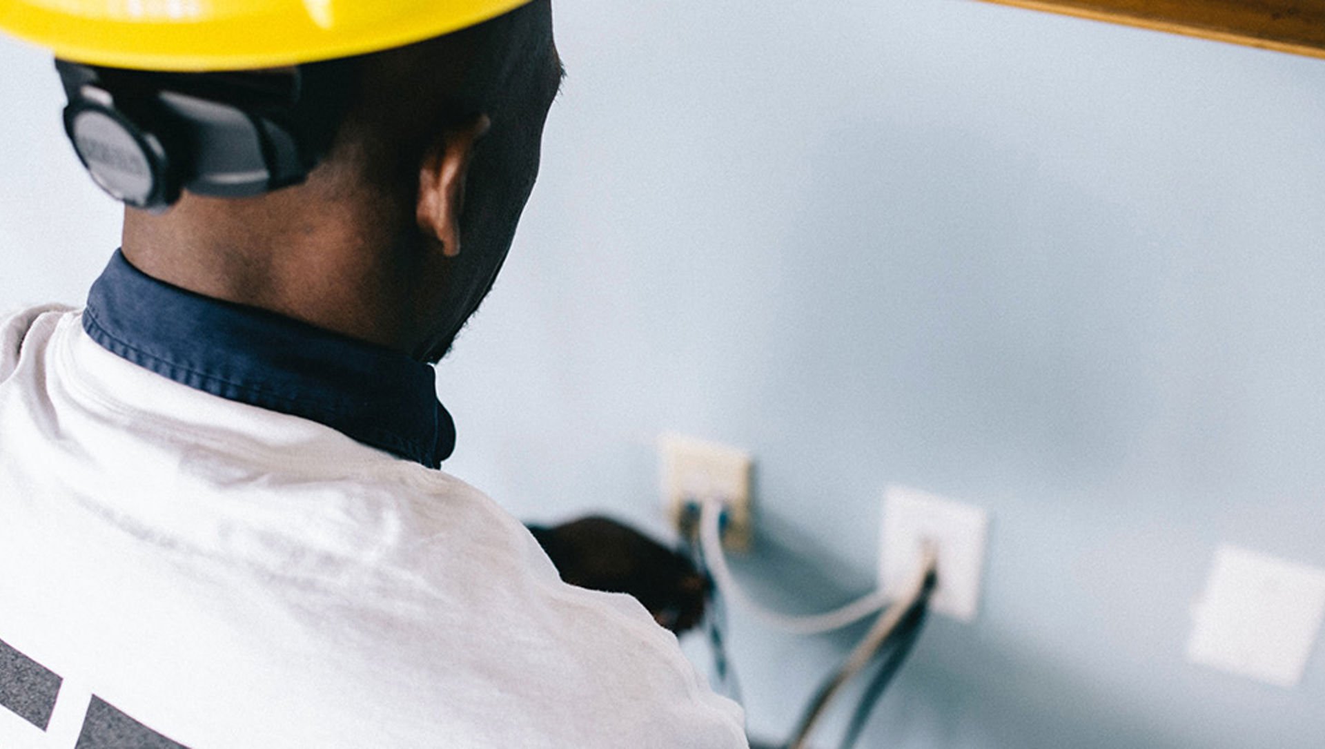 Field engineer installing a phone line in someone's home